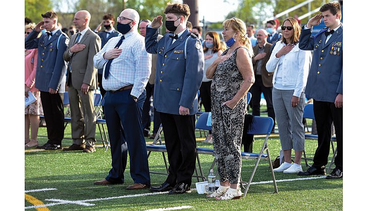 La Salle Institute in Troy held its graduation ceremony for its senior class on May 14 at its turf field. Dr. Chris Gibson, president of Siena College, decorated Army officer and a former member of the U.S. House of Representatives, was the keynote speaker. The 60 members of the class of 2021 were collectively accepted to 117 colleges and universities in 21 states and the District of Columbia and earned 163 scholarships totaling more than $11.9 million over four years. To remain compliant and adhering to all CDC and NYS guidelines, attendance was invite-only and the ceremony was livestreamed to accommodate those unable to attend in person.   Caption: Graduates join their parents and salute during the playing of the National Anthem.  Cindy Schultz photos  