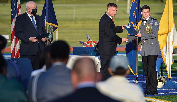 La Salle Institute in Troy held its graduation ceremony for its senior class on May 14 at its turf field. Dr. Chris Gibson, president of Siena College, decorated Army officer and a former member of the U.S. House of Representatives, was the keynote speaker. The 60 members of the class of 2021 were collectively accepted to 117 colleges and universities in 21 states and the District of Columbia and earned 163 scholarships totaling more than $11.9 million over four years. To remain compliant and adhering to all CDC and NYS guidelines, attendance was invite-only and the ceremony was livestreamed to accommodate those unable to attend in person.   Caption: Chris Gibson, former U.S. Representative and current president of Siena College, gives graduate Cadet Lieutenant Colonel Daniel Whalen the Assoc. of the U.S. Army Scholarship Award during commencement exercises.  Cindy Schultz photos  