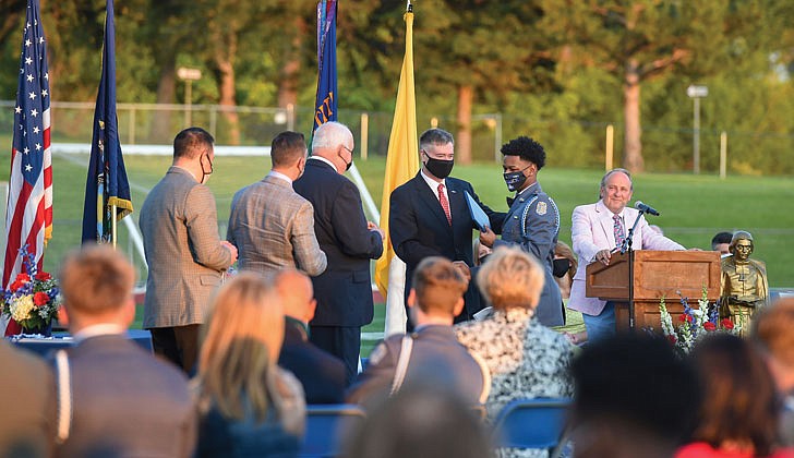 La Salle Institute in Troy held its graduation ceremony for its senior class on May 14 at its turf field. Dr. Chris Gibson, president of Siena College, decorated Army officer and a former member of the U.S. House of Representatives, was the keynote speaker. The 60 members of the class of 2021 were collectively accepted to 117 colleges and universities in 21 states and the District of Columbia and earned 163 scholarships totaling more than $11.9 million over four years. To remain compliant and adhering to all CDC and NYS guidelines, attendance was invite-only and the ceremony was livestreamed to accommodate those unable to attend in person.   Caption: Dr. Chris Gibson, former U.S. Representative and current president of Siena College, second from right, gives graduate Frederick Wagner-Glascoe his diploma.  Cindy Schultz photos  