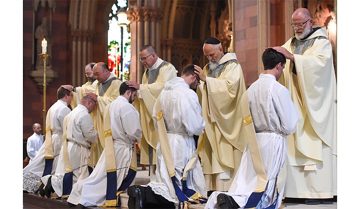 Deacons Matthew Duclos, Kyle Gorenski, Daniel McHale, Nathaniel Resila and Stephen Yusko were ordained into the priesthood at the Cathedral of the Immaculate Conception in Albany by Bishop Edward B. Scharfenberger on June 19.   Priests lay their hands upon the candidates.  Photos by Cindy Schultz  