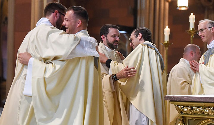 Deacons Matthew Duclos, Kyle Gorenski, Daniel McHale, Nathaniel Resila and Stephen Yusko were ordained into the priesthood at the Cathedral of the Immaculate Conception in Albany by Bishop Edward B. Scharfenberger on June 19.   Newly-ordained priest Daniel McHale (c.) is welcomed into the priesthood.  Photos by Cindy Schultz  