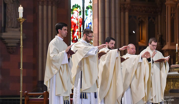 Deacons Matthew Duclos, Kyle Gorenski, Daniel McHale, Nathaniel Resila and Stephen Yusko were ordained into the priesthood at the Cathedral of the Immaculate Conception in Albany by Bishop Edward B. Scharfenberger on June 19.   The newly-ordained priests pray over the gifts.  Photos by Cindy Schultz  