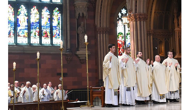 Deacons Matthew Duclos, Kyle Gorenski, Daniel McHale, Nathaniel Resila and Stephen Yusko were ordained into the priesthood at the Cathedral of the Immaculate Conception in Albany by Bishop Edward B. Scharfenberger on June 19.   Newly-ordained priests join fellow priests in saying the "Our Father."  Photos by Cindy Schultz  