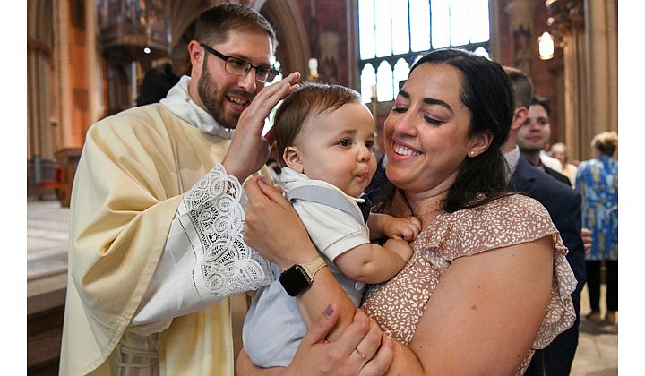 Deacons Matthew Duclos, Kyle Gorenski, Daniel McHale, Nathaniel Resila and Stephen Yusko were ordained into the priesthood at the Cathedral of the Immaculate Conception in Albany by Bishop Edward B. Scharfenberger on June 19.   Newly-ordained priest Stephen Yusko blesses his 8-month-old nephew, Luca Yusko, who is being held by his mother, Alyssa.  Photos by Cindy Schultz  