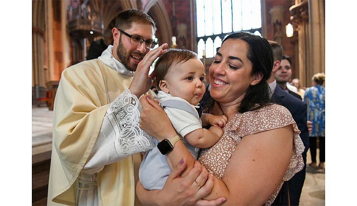Father Stephen Yusko blesses his 8-month-old nephew, Luca Yusko, as he’s being held by his mother, Alyssa Yusko, following Father Yusko's ordination to the priesthood on June 19 at the Cathedral of the Immaculate Conception in Albany.  (Cindy Schultz for The Evangelist)