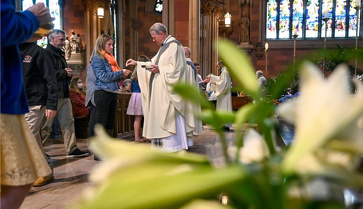 Bishop Edward B. Scharfenberger celebrated Easter Sunday Mass at the Cathedral of the Immaculate Conception in Albay on April 17. Here is a pictorial look back!  Caption: Bishop Scharfenberger distributes Communion during Mass.  Photos by Cindy Schultz