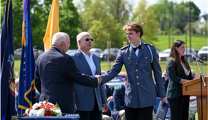 La Salle Institute honored its graduating class of 2022 — the last all-male class — with a formal, in-person commencement ceremony May 14 on the school’s athletic field. The ceremony featured John Thero ’79, former president and CEO of Amarin Corporation, as guest speaker. “I am exceptionally proud of this group of young men. They have conquered challenges and persevered despite unprecedented challenges, and they have proven to be extraordinary,” said La Salle Institute President and Head of School Joseph Raczkowski ’72. “They will attend college this fall at Notre Dame, Cornell University, UNC-Chapel Hill and The Citadel, to name a few. 18 young men will continue their athletic careers in college, including four at the Division 1 level. To say I am proud is an understatement, and I have no doubt they will go on to have great success in college and life.” Members of the class of 2022 were accepted to 141 colleges and universities in 28 states and the District of Columbia and earned more than $12.4 million in scholarships. In October 2020, La Salle announced its Mission Expansion Initiative, a shift to a co-educational model which began in September 2021.  Graduate Jacob Kochanskyj receives his diploma and shakes hands with Head of School Joseph B. Raczkowski,  Cindy Schultz photos for The Evangelist