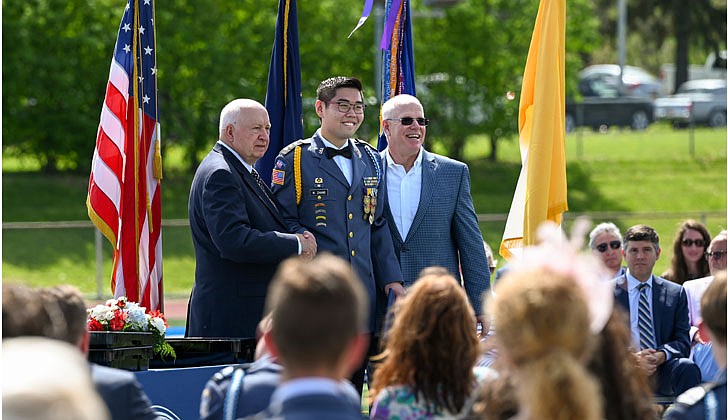 La Salle Institute honored its graduating class of 2022 — the last all-male class — with a formal, in-person commencement ceremony May 14 on the school’s athletic field. The ceremony featured John Thero ’79, former president and CEO of Amarin Corporation, as guest speaker. “I am exceptionally proud of this group of young men. They have conquered challenges and persevered despite unprecedented challenges, and they have proven to be extraordinary,” said La Salle Institute President and Head of School Joseph Raczkowski ’72. “They will attend college this fall at Notre Dame, Cornell University, UNC-Chapel Hill and The Citadel, to name a few. 18 young men will continue their athletic careers in college, including four at the Division 1 level. To say I am proud is an understatement, and I have no doubt they will go on to have great success in college and life.” Members of the class of 2022 were accepted to 141 colleges and universities in 28 states and the District of Columbia and earned more than $12.4 million in scholarships. In October 2020, La Salle announced its Mission Expansion Initiative, a shift to a co-educational model which began in September 2021.  Graduate Wangyong “Tom” Zhang poses for a picture with Head of School Joseph B. Raczkowski (l.) and commencement speaker John Thero.  Cindy Schultz photos for The Evangelist