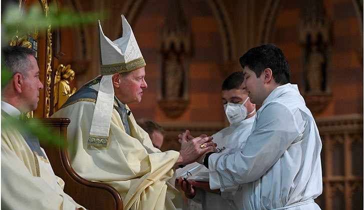 Deacon Daniel Vallejo was ordained as a transitional deacon at the Cathedral of the Immaculate Conception in Albany on May 21 with Bishop Edward B. Scharfenberger presiding. Deacon Vallejo, who was profiled in a story in The Evangelist on May 19, will join Father Quy Vo at Holy Spirit Church in East Greenbush from June until December, learning about how to be a priest on a daily basis; such as being able to baptize and marry people while assisting the pastor in the Masses. Then it is one more semester at St. Mary of the Lake Seminary in Mundelein, Ill., before his ordination to the priesthood next June at the Cathedral.  Bishop Edward B. Scharfenberger asks for the promise of obedience from Daniel Vallejo.  Cindy Schultz photos for The Evangelist.