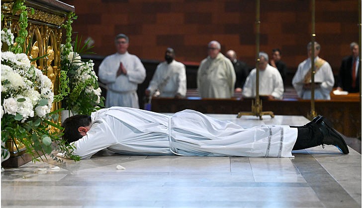 Deacon Daniel Vallejo was ordained as a transitional deacon at the Cathedral of the Immaculate Conception in Albany on May 21 with Bishop Edward B. Scharfenberger presiding. Deacon Vallejo, who was profiled in a story in The Evangelist on May 19, will join Father Quy Vo at Holy Spirit Church in East Greenbush from June until December, learning about how to be a priest on a daily basis; such as being able to baptize and marry people while assisting the pastor in the Masses. Then it is one more semester at St. Mary of the Lake Seminary in Mundelein, Ill., before his ordination to the priesthood next June at the Cathedral.  Daniel Vallejo prostrates during the Litany of Supplication.  Cindy Schultz photos for The Evangelist.