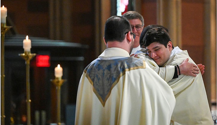 Deacon Daniel Vallejo was ordained as a transitional deacon at the Cathedral of the Immaculate Conception in Albany on May 21 with Bishop Edward B. Scharfenberger presiding. Deacon Vallejo, who was profiled in a story in The Evangelist on May 19, will join Father Quy Vo at Holy Spirit Church in East Greenbush from June until December, learning about how to be a priest on a daily basis; such as being able to baptize and marry people while assisting the pastor in the Masses. Then it is one more semester at St. Mary of the Lake Seminary in Mundelein, Ill., before his ordination to the priesthood next June at the Cathedral.  Deacon Daniel Vallejo (r.) smiles as he’s vested with stole and dalmatic during his Ordination to the Diaconate.   Cindy Schultz photos for The Evangelist.