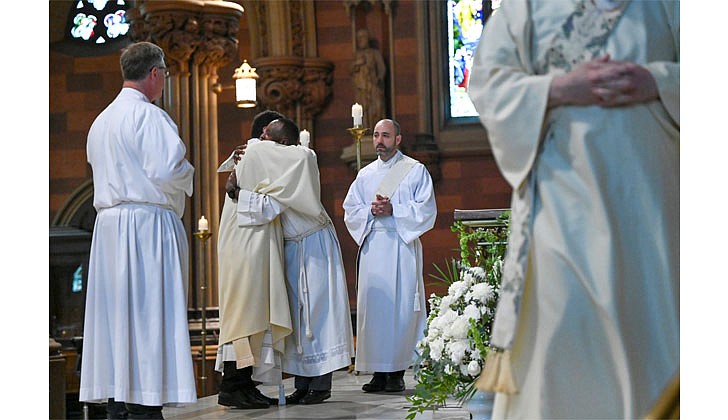 Deacon Daniel Vallejo was ordained as a transitional deacon at the Cathedral of the Immaculate Conception in Albany on May 21 with Bishop Edward B. Scharfenberger presiding. Deacon Vallejo, who was profiled in a story in The Evangelist on May 19, will join Father Quy Vo at Holy Spirit Church in East Greenbush from June until December, learning about how to be a priest on a daily basis; such as being able to baptize and marry people while assisting the pastor in the Masses. Then it is one more semester at St. Mary of the Lake Seminary in Mundelein, Ill., before his ordination to the priesthood next June at the Cathedral.  Deacon Daniel Vallejo  (c.) is welcomed into the fraternity of deacons during his Ordination to the Diaconate.   Cindy Schultz photos for The Evangelist.