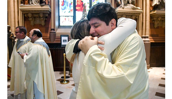 Deacon Daniel Vallejo was ordained as a transitional deacon at the Cathedral of the Immaculate Conception in Albany on May 21 with Bishop Edward B. Scharfenberger presiding. Deacon Vallejo, who was profiled in a story in The Evangelist on May 19, will join Father Quy Vo at Holy Spirit Church in East Greenbush from June until December, learning about how to be a priest on a daily basis; such as being able to baptize and marry people while assisting the pastor in the Masses. Then it is one more semester at St. Mary of the Lake Seminary in Mundelein, Ill., before his ordination to the priesthood next June at the Cathedral.  Deacon Daniel Vallejo embraces his aunt Ana Valbuena after his ordination.  Cindy Schultz photos for The Evangelist.