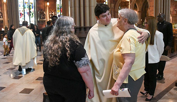 Deacon Daniel Vallejo was ordained as a transitional deacon at the Cathedral of the Immaculate Conception in Albany on May 21 with Bishop Edward B. Scharfenberger presiding. Deacon Vallejo, who was profiled in a story in The Evangelist on May 19, will join Father Quy Vo at Holy Spirit Church in East Greenbush from June until December, learning about how to be a priest on a daily basis; such as being able to baptize and marry people while assisting the pastor in the Masses. Then it is one more semester at St. Mary of the Lake Seminary in Mundelein, Ill., before his ordination to the priesthood next June at the Cathedral.  Deacon Daniel Vallejo Rios  talks with Kathy Hein (r.) and Deborah Toce after his ordination.  Cindy Schultz photos for The Evangelist.