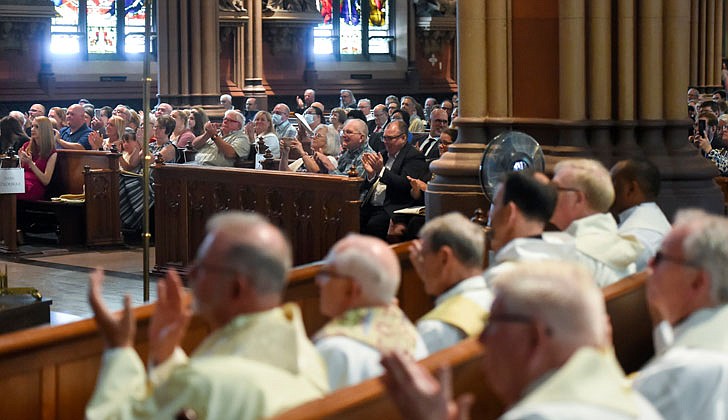 Calling the priesthood “a ministry of love,” Bishop Edward B. Scharfenberger of the Diocese of Albany presided over the Ordination to the Priesthood of Father Russell Bergman and Father James O’Rourke - who were both profiled in last week’s The Evangelist - on June 18 at the Cathedral of the Immaculate Conception in Albany.  Father O’Rourke celebrated his first Mass at Blessed Sacrament in Albany on June 19, while Father Bergman celebrated his first Mass at Our Lady of Victory in Troy.  Father Bergman said of his ordination: “It was beyond comparison to any experience I’ve had in my life. An awesome experience in the true divine sense of awesome, full of humility, joy, wonder, intensity, thanksgiving, fulfillment and palpable love, among so many other feelings that words alone cannot capture.”   The parish assignments for both priests are expected to be announced on June 27.  Parishioners, priests and deacons applaud for the candidates for ordination.  Cindy Schultz photos for The Evangelist. 