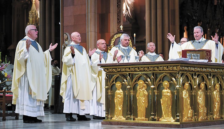 Calling the priesthood “a ministry of love,” Bishop Edward B. Scharfenberger of the Diocese of Albany presided over the Ordination to the Priesthood of Father Russell Bergman and Father James O’Rourke - who were both profiled in last week’s The Evangelist - on June 18 at the Cathedral of the Immaculate Conception in Albany.  Father O’Rourke celebrated his first Mass at Blessed Sacrament in Albany on June 19, while Father Bergman celebrated his first Mass at Our Lady of Victory in Troy.  Father Bergman said of his ordination: “It was beyond comparison to any experience I’ve had in my life. An awesome experience in the true divine sense of awesome, full of humility, joy, wonder, intensity, thanksgiving, fulfillment and palpable love, among so many other feelings that words alone cannot capture.”   The parish assignments for both priests are expected to be announced on June 27.  Newly ordained priests James O’Rourke (from l.) and Russell Bergman join fellow priests and Bishop Edward B. Scharfenberger at the altar for the Liturgy of the Eucharist.  Cindy Schultz photos for The Evangelist. 