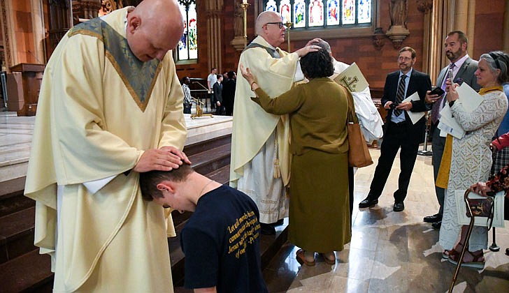 Calling the priesthood “a ministry of love,” Bishop Edward B. Scharfenberger of the Diocese of Albany presided over the Ordination to the Priesthood of Father Russell Bergman and Father James O’Rourke - who were both profiled in last week’s The Evangelist - on June 18 at the Cathedral of the Immaculate Conception in Albany.  Father O’Rourke celebrated his first Mass at Blessed Sacrament in Albany on June 19, while Father Bergman celebrated his first Mass at Our Lady of Victory in Troy.  Father Bergman said of his ordination: “It was beyond comparison to any experience I’ve had in my life. An awesome experience in the true divine sense of awesome, full of humility, joy, wonder, intensity, thanksgiving, fulfillment and palpable love, among so many other feelings that words alone cannot capture.”   The parish assignments for both priests are expected to be announced on June 27.  Newly ordained priests, Father Russell Bergman (l.) and Father James O’Rourke, bless parishioners following their Ordination.  Cindy Schultz photos for The Evangelist.  