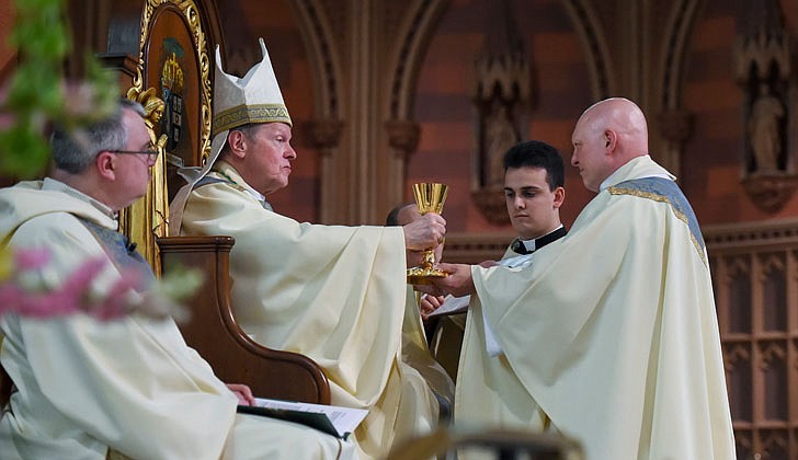 Calling the priesthood “a ministry of love,” Bishop Edward B. Scharfenberger of the Diocese of Albany presided over the Ordination to the Priesthood of Father Russell Bergman and Father James O’Rourke - who were both profiled in last week’s The Evangelist - on June 18 at the Cathedral of the Immaculate Conception in Albany.  Father O’Rourke celebrated his first Mass at Blessed Sacrament in Albany on June 19, while Father Bergman celebrated his first Mass at Our Lady of Victory in Troy.  Father Bergman said of his ordination: “It was beyond comparison to any experience I’ve had in my life. An awesome experience in the true divine sense of awesome, full of humility, joy, wonder, intensity, thanksgiving, fulfillment and palpable love, among so many other feelings that words alone cannot capture.”   The parish assignments for both priests are expected to be announced on June 27.  Bishop Edward B. Scharfenberger presents the chalice to newly ordained priest Russell Bergman.  Cindy Schultz photos for The Evangelist.