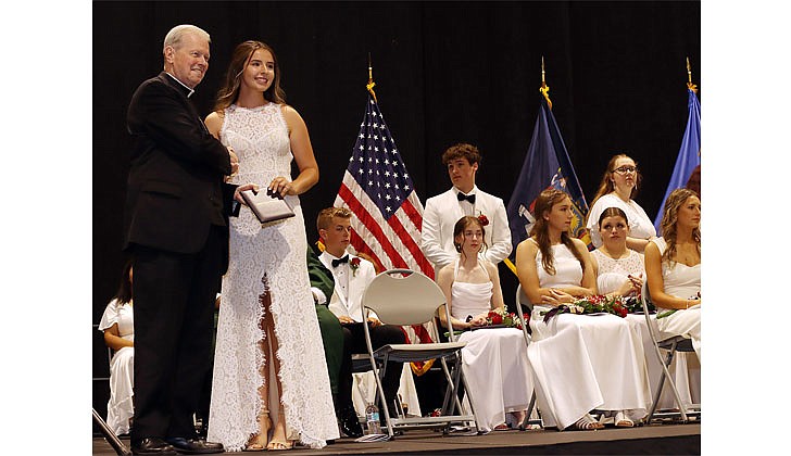 Catholic Central High School held its 99th Commencement Ceremony at Hudson Valley Community College on June 25. The graduating class of 46 seniors received $6.5 million in college scholarships, grants and aid. Catholic High will merge with St. Ambrose School in Latham to form Catholic Central School, a pre-K through Grade 12 regional Catholic school, in Latham. The doors to the new school open in September.  Bishop Edward B. Scharfenberger presents Madeline Finn with her diploma during CCHS' 99th Commencement Ceremony.  Photos by Thomas Killips