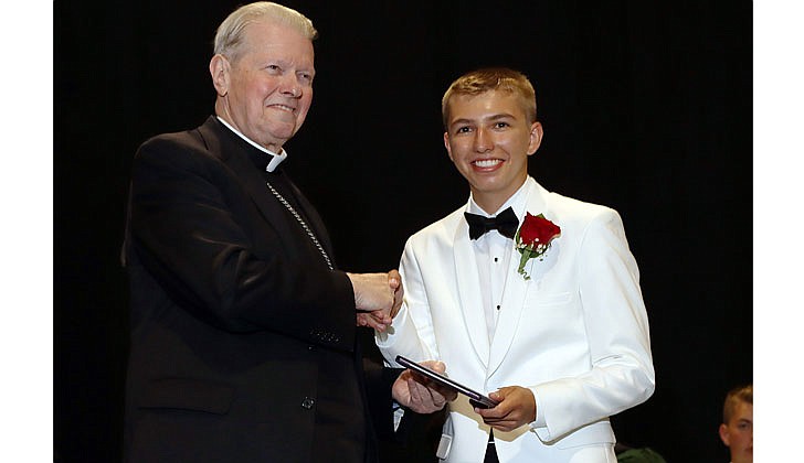 Catholic Central High School held its 99th Commencement Ceremony at Hudson Valley Community College on June 25. The graduating class of 46 seniors received $6.5 million in college scholarships, grants and aid. Catholic High will merge with St. Ambrose School in Latham to form Catholic Central School, a pre-K through Grade 12 regional Catholic school, in Latham. The doors to the new school open in September.  Bishop Edward B. Scharfenberger presents Patrick Casale with his diploma during the commencement.  Photos by Thomas Killips