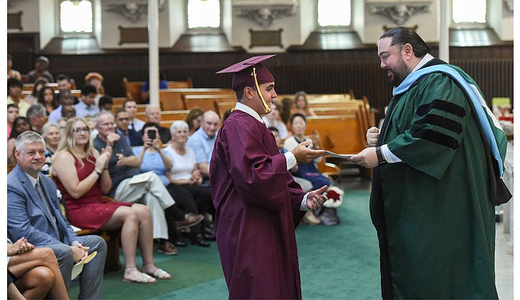 Notre Dame-Bishop Gibbons School held its Commencement Ceremony on June 25 at St. John the Evangelist Church in Schenectady. With a 100 percent graduation rate, the 33 seniors received over $8 million dollars in scholarships and grants for college over four years. In addition, they were accepted into 65 colleges and universities in 12 states and 20 New York counties.   Graduate Colin Campbell receives an academic award from Giovanni Virgiglio Jr., superintendent of schools.  Cindy Schultz photos for The Evangelist