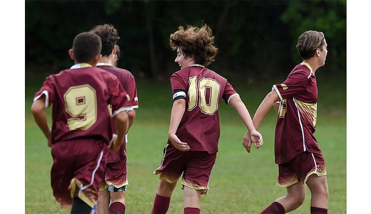 Nicholas Kuban (10) celebrates with teammates after scoring one of his two goals in Notre Dame-Bishop Gibbons School's 2-0 win over Saratoga Central Catholic School on Sept. 3. (Cindy Schultz photo for The Evangelist)