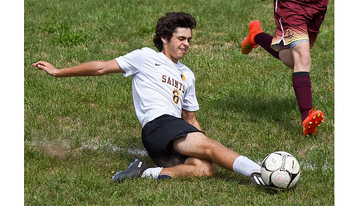 Saratoga Central Catholic’s Aidan Crother slides to keep the ball inbounds during his team's soccer game against Notre Dame-Bishop Gibbons on Sept. 3. (Cindy Schultz photo for The Evangelist)