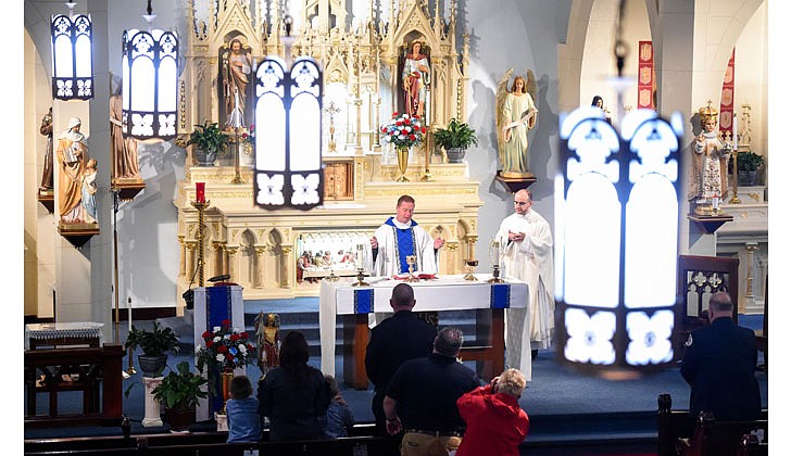 The parishes of St. Michael’s in Cohoes, Holy Trinity in Cohoes, St. Ambrose in Latham and Immaculate Heart of Mary in Watervliet celebrated the Feast of St. Michael the Archangel on Oct. 1 with a Mass at St. Michael’s that was offered for the City of Cohoes’ first responders and presided over by Father Brian Kelly. St. Michael is the patron saint of first responders. After the Mass, there was a lunch with games for the children and demonstrations by the police and fire companies.   Father Brian Kelly (c.) and Father Samuel Bellafiore preside over the Mass to celebrate and thank the City of Cohoes' first responders.  Photos by Cindy Schultz for The Evangelist   