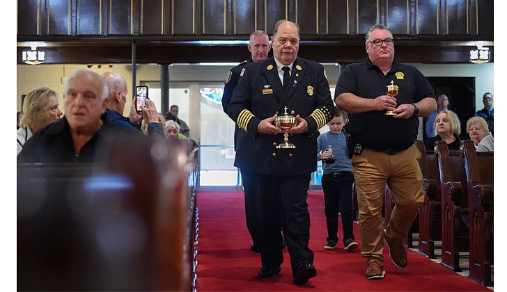 The parishes of St. Michael’s in Cohoes, Holy Trinity in Cohoes, St. Ambrose in Latham and Immaculate Heart of Mary in Watervliet celebrated the Feast of St. Michael the Archangel on Oct. 1 with a Mass at St. Michael’s that was offered for the City of Cohoes’ first responders and presided over by Father Brian Kelly. St. Michael is the patron saint of first responders. After the Mass, there was a lunch with games for the children and demonstrations by the police and fire companies.   First responders carry the offertory gifts during the Mass. In front are Cohoes Fire Chief Joseph Fahd (l.) and Detective Matthew LaBombard, and in back is Cohoes Police Chief Todd Waldinand his son, Graham Waldin, 6.  Photos by Cindy Schultz for The Evangelist