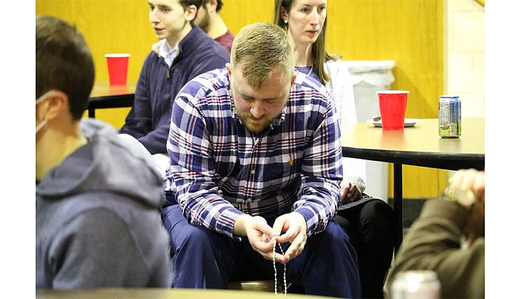 Matt Dorry prays during Real Talk Rosary's first gathering on Jan. 18. Real Talk Rosary is a diocesan young-adult initiative designed to give millennial Catholics a place to decompress and find peace in the Rosary.  Molly Halpin photo