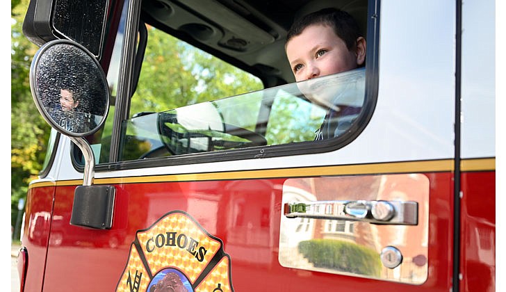 Gianni Izzo, 7, sits in the driver’s seat of a Cohoes Fire Department hook and ladder truck on Oct. 1 after the parishes of St. Michael and Archangel in Troy, Holy Trinity in Cohoes, St. Ambrose in Latham and Immaculate Heart of Mary in Watervliet celebrated the Feast of St. Michael the Archangel with a Mass at St. Michael’s that was offered for the City of Cohoes’ first responders and presided over by Father Brian Kelly and Father Samuel Bellafiore.  Cindy Schultz photo for The Evangelist