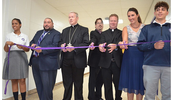 Bishop Edward B. Scharfenberger leads the ribbon-cutting ceremony to officially open Catholic Central School in Latham on Sept. 15.  Cindy Schultz photo for The Evangelist