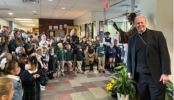 Bishop Scharfenberger blesses the Jesus statue at St. Thomas the Apostle School in Delmar on Sept. 29.  Emily Benson photo 
