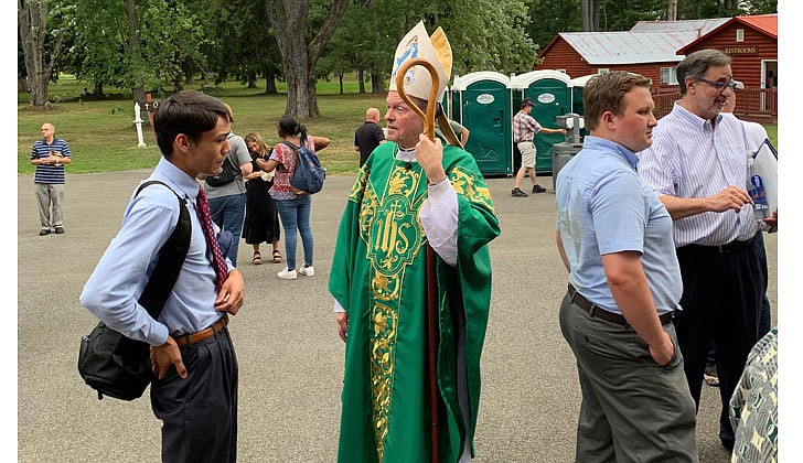 Bishop Scharfenberger talks with attendees at the Step Up Men's Conference at Our Lady of Martyrs Shrine in Auriesville on Aug. 20.  