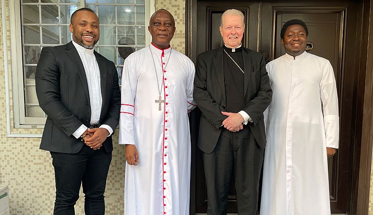 On his mission trip to Nigeria from Feb. 8-16, Bishop Edward B. Scharfenberger, who was accompanied by Father Charles Onyeneke, parochial vicar at Blessed Sacrament Parish in Albany, got to meet the people of the Archdiocese of Lagos, celebrated Mass and met with potential seminarians who could eventually make their way to the Diocese of Albany.  Bishop stayed in the Parish of St. Charles Borromeo, Victoria Island, Lagos, the entire time. Some highlights included: Meeting with Archbishop Alfred Martins in his residence at the Cathedral in Lagos on Feb. 10; visiting the Church of St. Mary in Ajegunle on Feb. 12 and saying Mass there; blessing the new Stella Maris rectory after Mass and having dinner with several priests and nuns; and meeting Father Philip Uchdendu, former secretary to the Archbishop of Lagos and current pastor of the parish of St. Peter Claver in Ajah, near the airport on Feb. 16.  The best thing about the journey is that it did not cost the Diocese a single penny. Father Onyeneke’s plane ticket was paid for with redeemed airline miles from Father Thomas Hoar, SSE, the diocesan director of Vocations and Formation, and Bishop’s expenses will be reimbursed by the Pontifical Mission Societies after the people of Nigeria asked him to visit.  Bishop takes a photo with Archbishop Martins, his secretary, Father Paul, and Father Onyeneke.