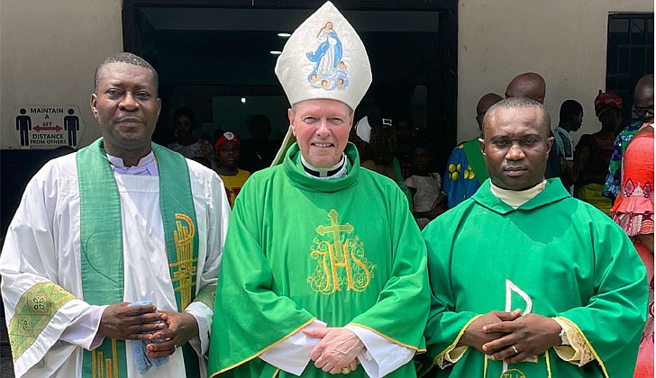 On his mission trip to Nigeria from Feb. 8-16, Bishop Edward B. Scharfenberger, who was accompanied by Father Charles Onyeneke, parochial vicar at Blessed Sacrament Parish in Albany, got to meet the people of the Archdiocese of Lagos, celebrated Mass and met with potential seminarians who could eventually make their way to the Diocese of Albany.  Bishop stayed in the Parish of St. Charles Borromeo, Victoria Island, Lagos, the entire time. Some highlights included: Meeting with Archbishop Alfred Martins in his residence at the Cathedral in Lagos on Feb. 10; visiting the Church of St. Mary in Ajegunle on Feb. 12 and saying Mass there; blessing the new Stella Maris rectory after Mass and having dinner with several priests and nuns; and meeting Father Philip Uchdendu, former secretary to the Archbishop of Lagos and current pastor of the parish of St. Peter Claver in Ajah, near the airport on Feb. 16.  The best thing about the journey is that it did not cost the Diocese a single penny. Father Onyeneke’s plane ticket was paid for with redeemed airline miles from Father Thomas Hoar, SSE, the diocesan director of Vocations and Formation, and Bishop’s expenses will be reimbursed by the Pontifical Mission Societies after the people of Nigeria asked him to visit.  Bishop takes a picture with two local priests.