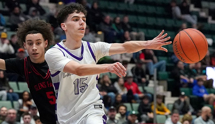 The Catholic Central boys’ basketball team made history on March 4 by defeating Glens Falls, 73-59, in the Section II Class B final at Cool Insuring Arena in Glens Falls for the program’s first section crown since 1981. The Crusaders were led by freshmen Darien Moore, who had 27 points and 13 rebounds and was named MVP of the tournament, and Sei’Mir Roberson, who added 21 points and earned all-tournament team honors.  The win was especially sweet for the young Crusaders who suffered a heart-breaking 51-50 loss to Ichabod Crane in last year’s finals. The rest of the Crusaders, who are led by coach Guy DiBacco, are freshman Xaul Arroyo, senior Conor Gemmill, freshman Qwameik Smith, eighth-grader Xavjon Arroyo, senior Nick Schrom, seventh-grader Aiden Prunty, senior Nick Riley, junior Danny Bologna and junior Brian Warncke.   Senior Nick Riley passes to a teammate.  Cindy Schultz photos for The Evangelist