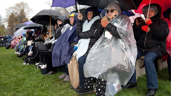 Thousands braved the rain and cold temperatures to attend Mass on Divine Mercy Sunday at the National Shrine of Divine Mercy in Stockbridge, Mass., on Sunday, April 28. Bishop Edward Scharfenberger celebrated the Mass, blesses the crowd with the heart of St. Jean Vianney, the patron saint of parish priests, and gives out communion along with other priests. Divine Mercy is based on St. Faustina Kowalska’s visions and conversations she had with Jesus Christ, who asked St. Faustina to paint the vision of Divine Mercy. Divine Mercy Sunday is the first Sunday after Easter. (Nate Whitchurch photos)