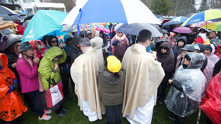 Thousands braved the rain and cold temperatures to attend Mass on Divine Mercy Sunday at the National Shrine of Divine Mercy in Stockbridge, Mass., on Sunday, April 28. Bishop Edward Scharfenberger celebrated the Mass, blesses the crowd with the heart of St. Jean Vianney, the patron saint of parish priests, and gives out communion along with other priests. Divine Mercy is based on St. Faustina Kowalska’s visions and conversations she had with Jesus Christ, who asked St. Faustina to paint the vision of Divine Mercy. Divine Mercy Sunday is the first Sunday after Easter. (Nate Whitchurch photos)