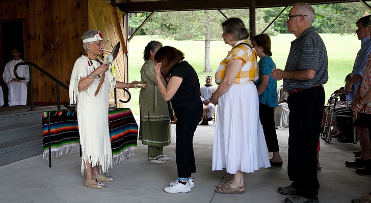 It was Saint Kateri Tekakwitha Feast Day weekend at the Saint Kateri Tekakwitha National Shrine and Historic Site in Fonda on July 13-14. Bishop Edward B. Scharfenberger celebrated Mass on Sunday along with Father James McCurry, OFM, and Father Tim Lyons. The Mass featured a smudging ritual and Four Direction Purification Ceremony.  Terry Steele smudges parishioners, blessing them with smoke from burning sage and other herbs.  Photos by Nate Whitchurch. 